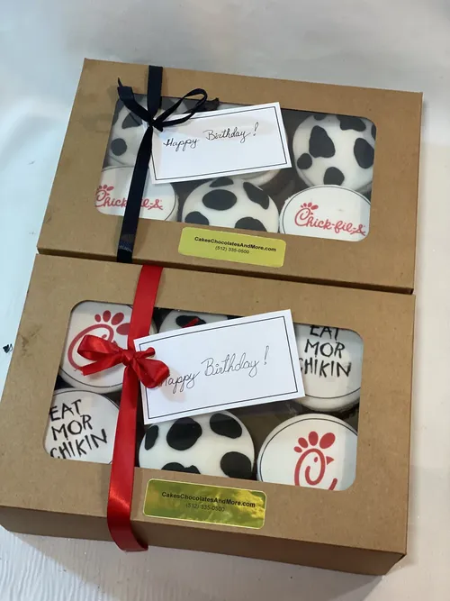 Chick-fil-A themed birthday cupcakes with cow print in gift boxes