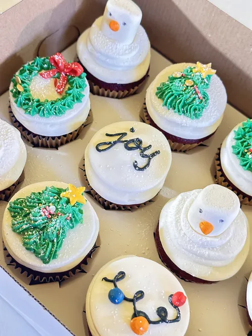 Christmas cupcakes with wreaths, trees, snowmen and JOY lettering