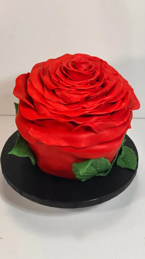 Sculpted giant red rose cake with fondant leaves